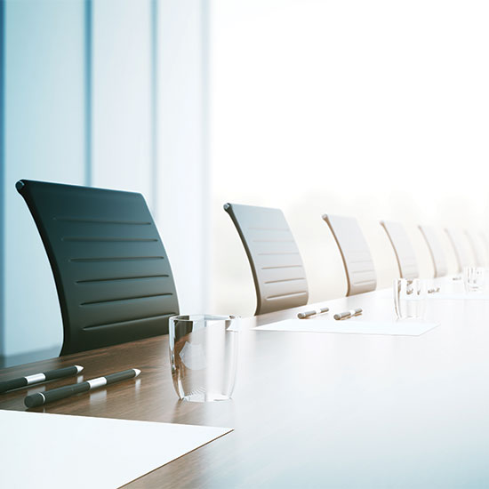 GLANCDA Board of Directors 2026; A sleek, modern conference room with a long wooden table, black chairs, paper, pens, and glasses of water. Bright, minimalistic and professional atmosphere.